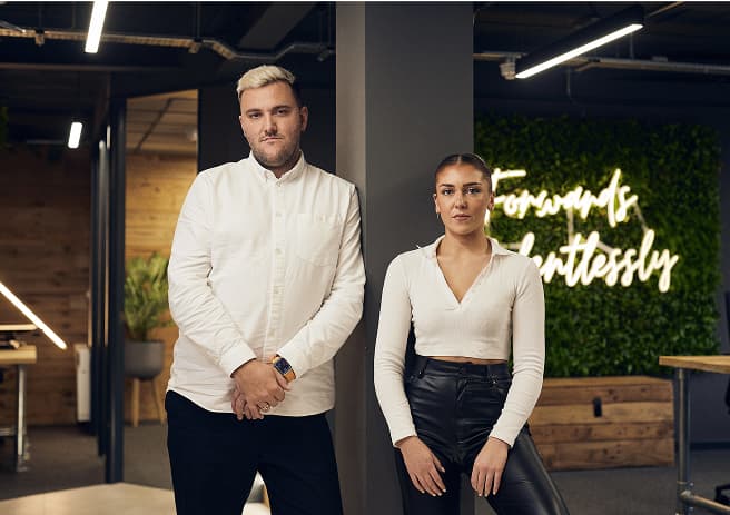 man and woman stood in a room 